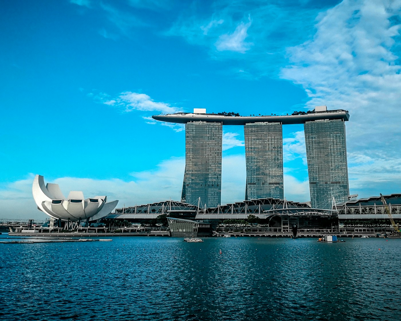 gray concrete buildings near body of water. Illustrative photograph; not a depiction of the named product or organisation.